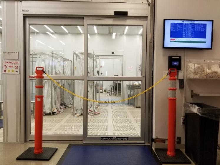 A glass door with a roped barrierDescription automatically generated with medium confidence