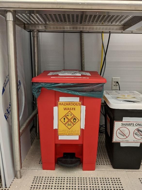 A red container with a green bag on itDescription automatically generated