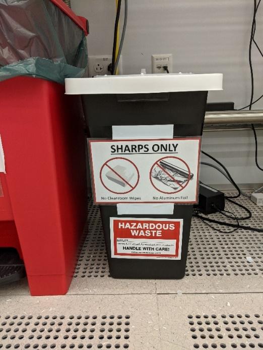 A black and white bin with a white lidDescription automatically generated