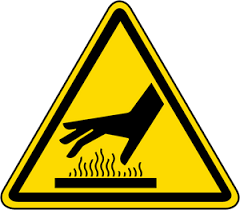 A yellow triangle sign with a hand over a surface